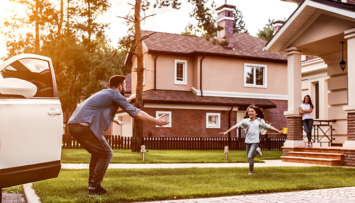 Little Girl Running to Give Her Dad A Hug As He Comes Home From Work