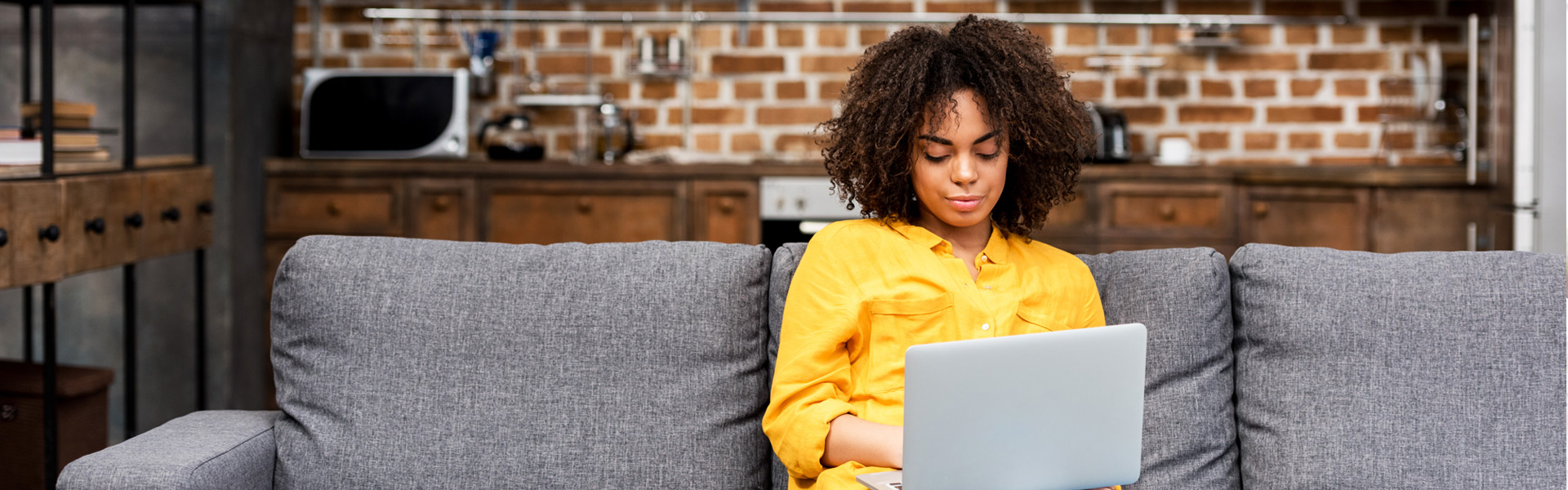 Young woman working on her computer in her living room