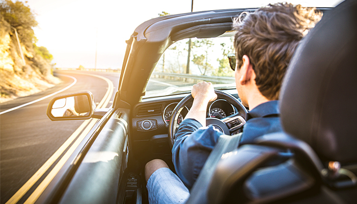 Young Man Driving A Convertible