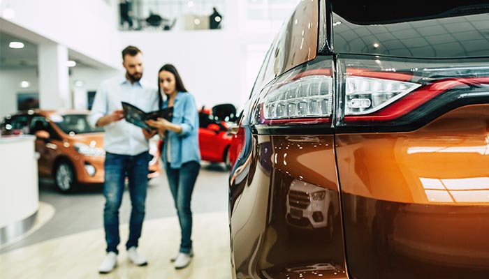 couple looking at car couple looking at car