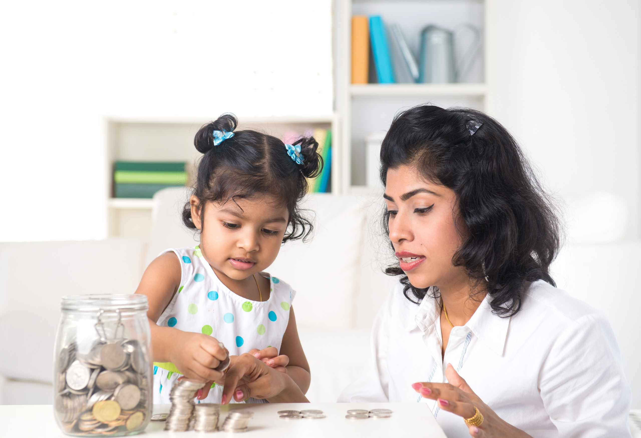 Mother teaching daughter on financial planning