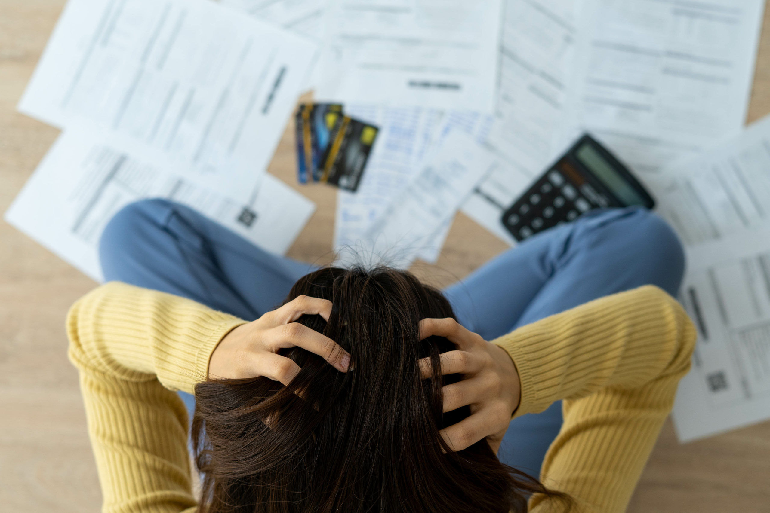 Women stress about a lot of credit card debt and bills on the fl Couple Painting House
