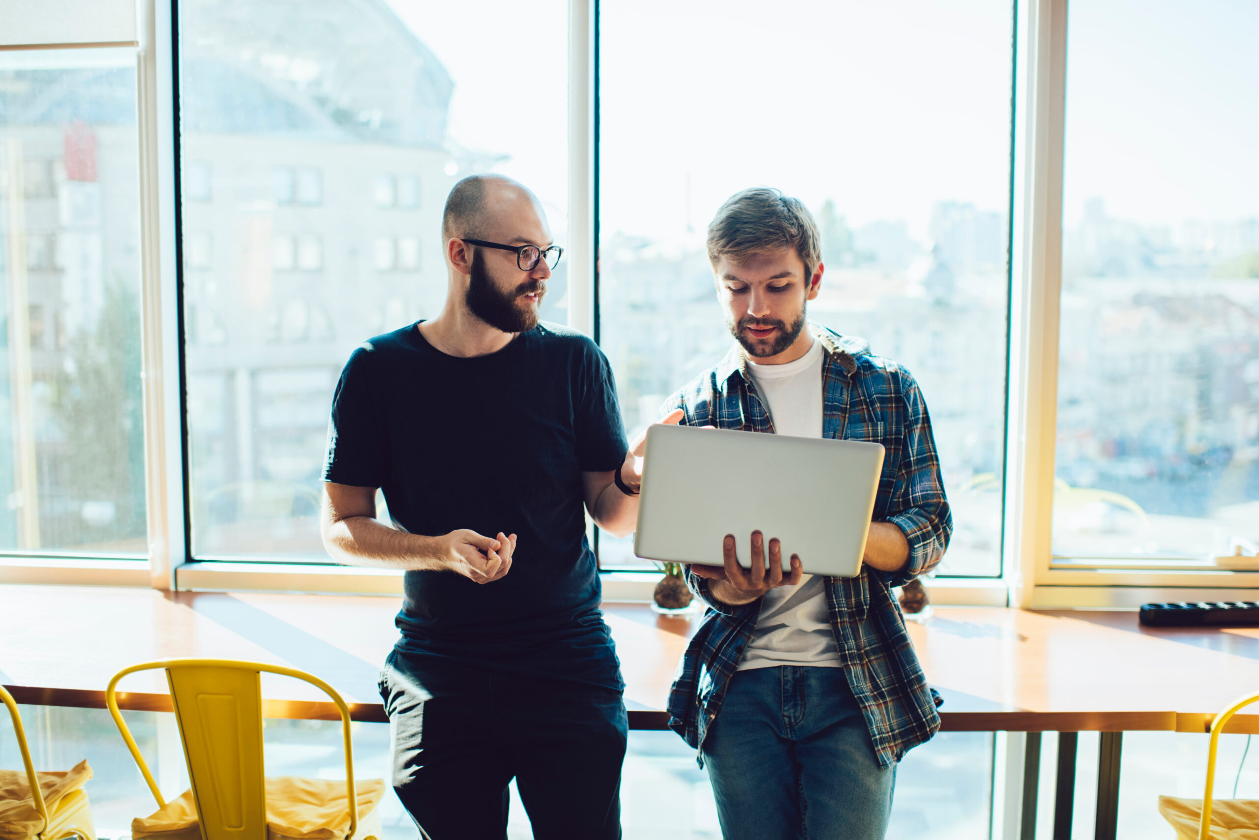 Focused men with laptop investing online Couple Painting House